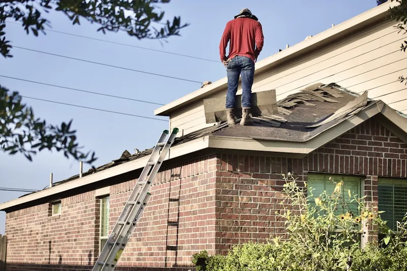 Professional roofer working on a residential roof in Flowood